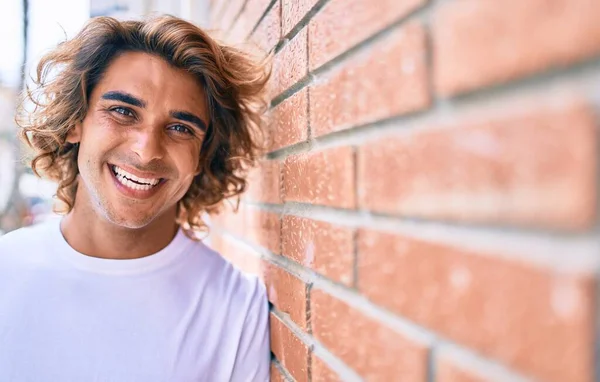 Joven Hombre Hispano Guapo Sonriendo Feliz Apoyado Pared Calle Ciudad —  Fotos de Stock
