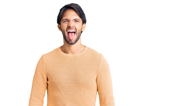 Handsome Hispanic Man Wearing Casual Sweater Sticking Tongue Out Happy — Stock Photo, Image