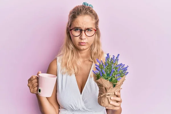 Young Blonde Girl Holding Cup Tea Herbal Plant Skeptic Nervous — Stock Photo, Image