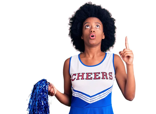 Young African American Woman Wearing Cheerleader Uniform Holding Pompom Amazed — Stock Photo, Image