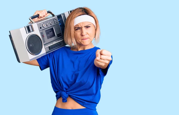 Young Blonde Woman Wearing Sportswear Holding Boombox Listening Music Annoyed — Stock Photo, Image