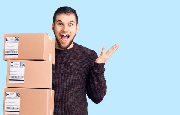 Young Handsome Man Holding Delivery Package Celebrating Victory Happy Smile — Stock Photo, Image