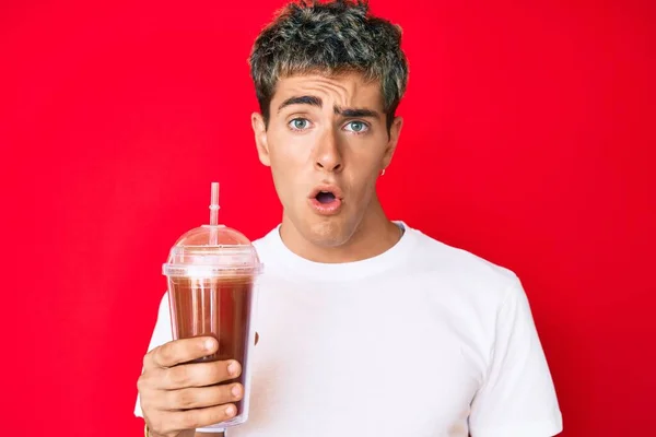 Young Handsome Man Holding Glass Smoothie Scared Amazed Open Mouth — Stock Photo, Image