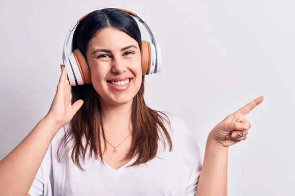 Young Beautiful Brunette Woman Listening Music Using Headphones White Background — Stock Photo, Image