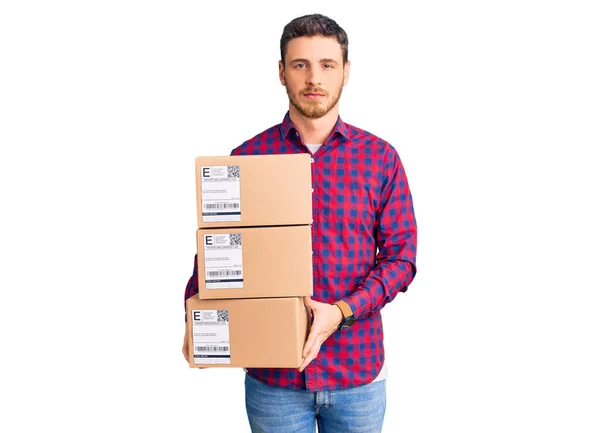 Handsome Young Man Bear Holding Delivery Packages Thinking Attitude Sober — Stock Photo, Image
