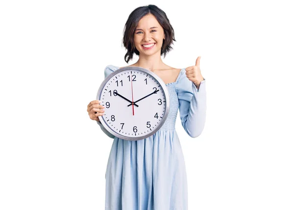 Jovem Menina Bonita Segurando Grande Relógio Sorrindo Feliz Positivo Polegar — Fotografia de Stock