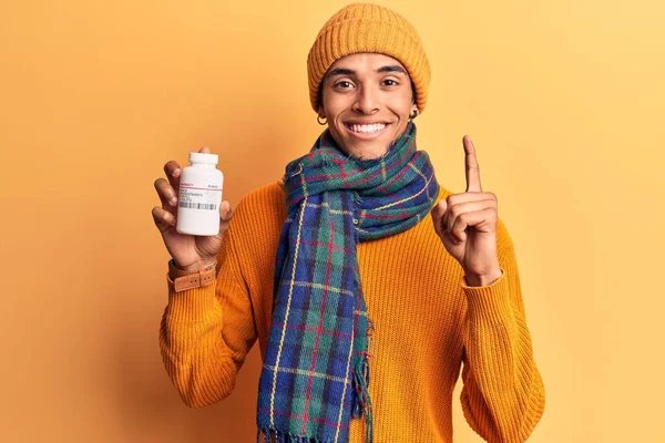 Young African Amercian Man Wearing Winter Clothes Holding Pills Smiling — Stock Photo, Image