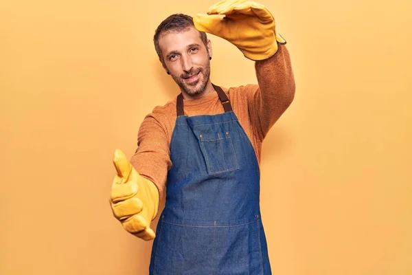 Jovem Bonitão Vestindo Avental Jardineiro Luvas Olhando Para Câmera Sorrindo — Fotografia de Stock