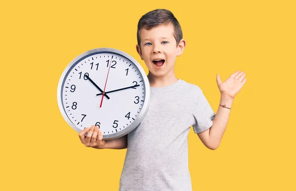 Cute Blond Kid Holding Big Clock Celebrating Victory Happy Smile — Stock Photo, Image