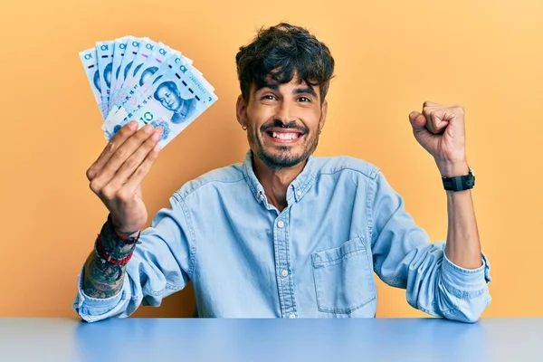 Junger Hispanischer Mann Hält Chinesische Yuan Banknoten Auf Dem Tisch — Stockfoto