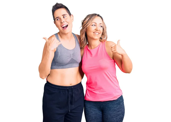 Couple Women Wearing Sportswear Smiling Happy Face Looking Pointing Side — Stock Photo, Image