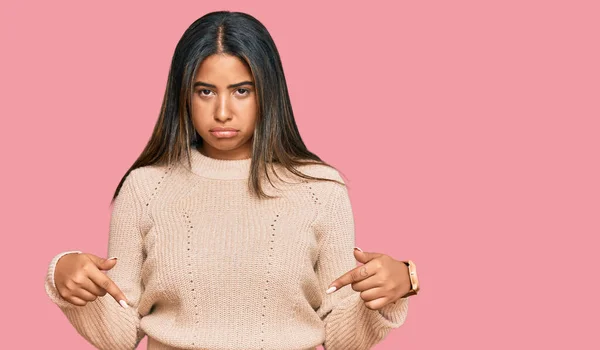 Young Latin Girl Wearing Wool Winter Sweater Pointing Looking Sad — Stock Photo, Image