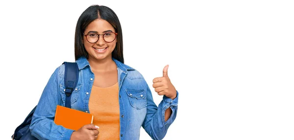 Menina Latina Usando Mochila Estudantil Segurando Livros Fazendo Polegares Felizes — Fotografia de Stock