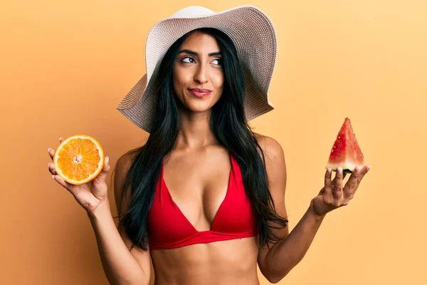 Beautiful Hispanic Woman Eating Watermelon Orange Smiling Looking Side Staring — Stock Photo, Image