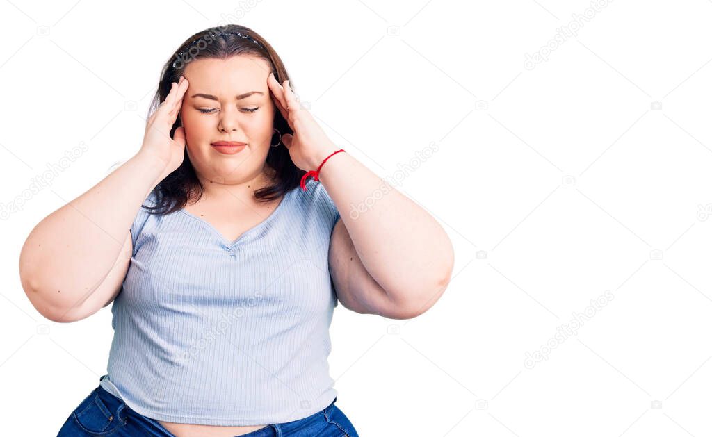 Young plus size woman wearing casual clothes with hand on head for pain in head because stress. suffering migraine. 