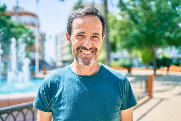 Middle age man with beard smiling happy outdoors