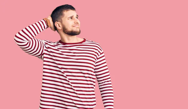 Young Handsome Man Wearing Striped Sweater Confuse Wondering Question Uncertain — Stock Photo, Image