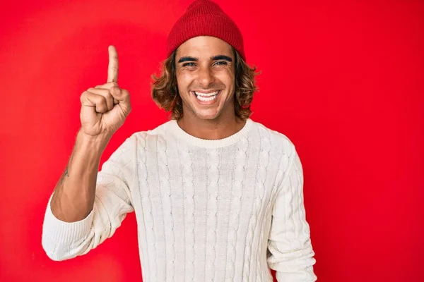 Young Hispanic Man Wearing Wool Sweater Winter Hat Pointing Finger — Stock Photo, Image