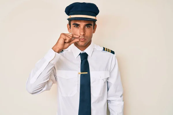 Young Hispanic Man Wearing Airplane Pilot Uniform Mouth Lips Shut — Stock Photo, Image