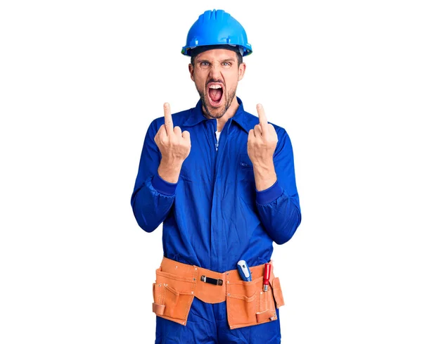 Young Handsome Man Wearing Worker Uniform Hardhat Showing Middle Finger — Stockfoto