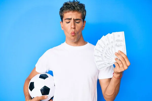 Young Handsome Man Holding Soccer Ball Dollars Banknotes Making Fish — Stock Photo, Image