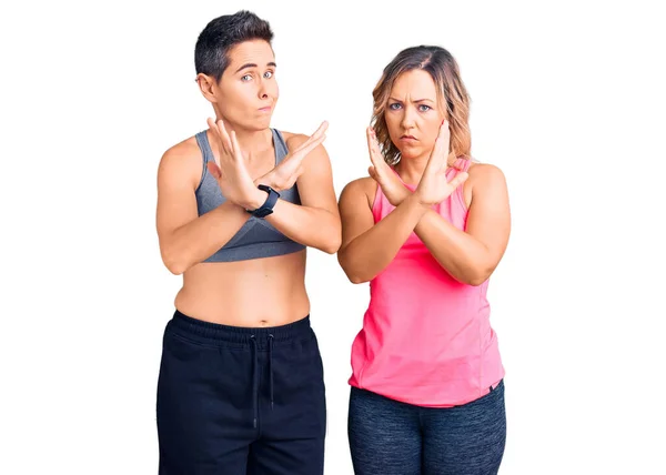 Couple Women Wearing Sportswear Rejection Expression Crossing Arms Doing Negative — Stock Photo, Image