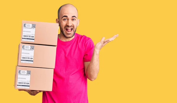 Young Handsome Man Holding Delivery Package Celebrating Victory Happy Smile — Stock Photo, Image