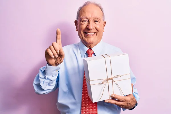 Senior Grey Haired Businessman Wearing Tie Holding Birthday Gift Pink — Stock Photo, Image