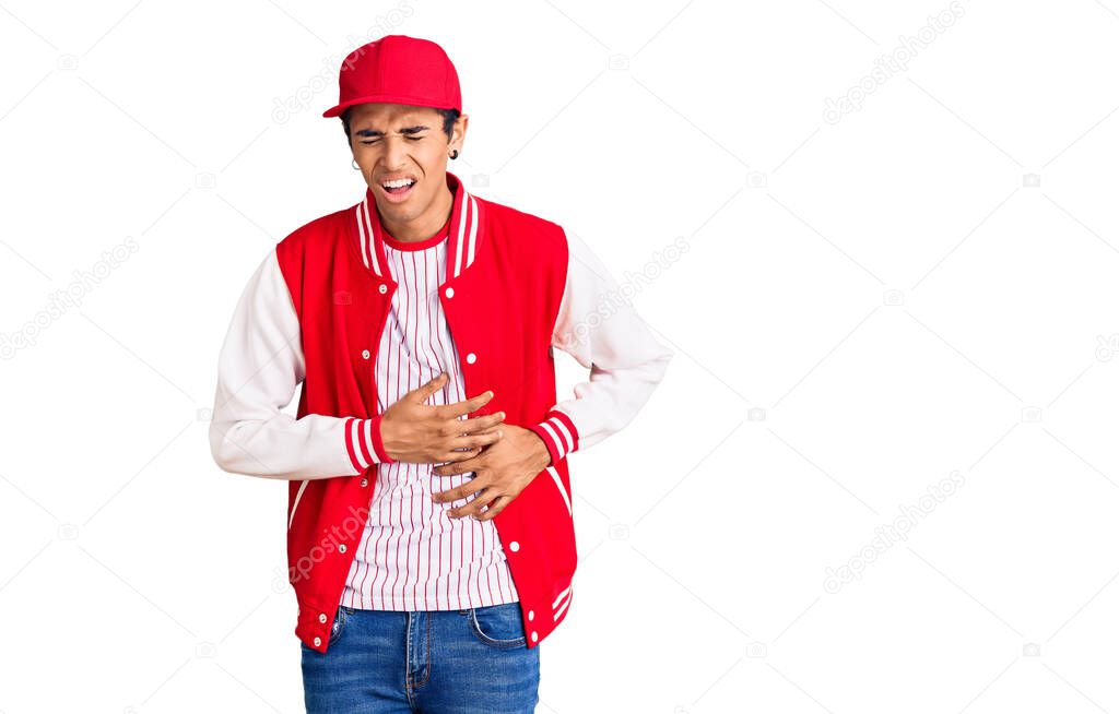 Young african amercian man wearing baseball uniform with hand on stomach because nausea, painful disease feeling unwell. ache concept. 