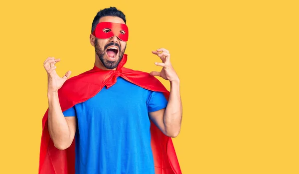 スーパーヒーローの衣装を着た若いヒスパニック系の男が狂った叫び 積極的な表現と腕を上げて叫びました フラストレーションコンセプト — ストック写真