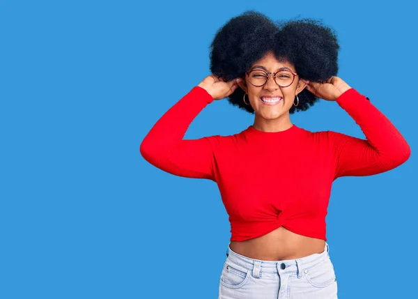 Jovem Afro Americana Vestindo Roupas Casuais Óculos Sorrindo Puxando Orelhas — Fotografia de Stock