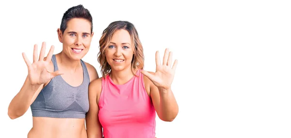 Couple Women Wearing Sportswear Showing Pointing Fingers Number Ten While — Stock Photo, Image