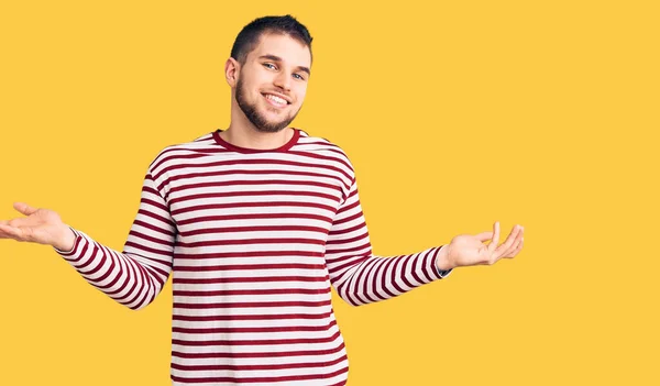 Young Handsome Man Wearing Striped Sweater Smiling Showing Both Hands — Stock Photo, Image