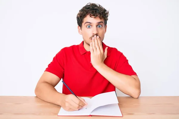 Young Caucasian Man Curly Hair Writing Notebook Sitting Table Covering — Stock Photo, Image