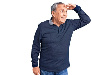 Kıdemli yakışıklı adam gündelik polo giyiyor. Çok mutlu ve gülümsüyor. Çok uzaklara bakıyor. arama kavramı. 