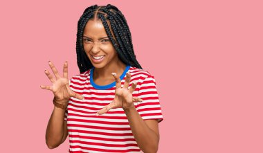 Güzel İspanyol kadın gündelik kıyafetler giyip gülümsüyor. Pençe hareketlerini kedi gibi yapıyor. Agresif ve seksi bir ifade. 