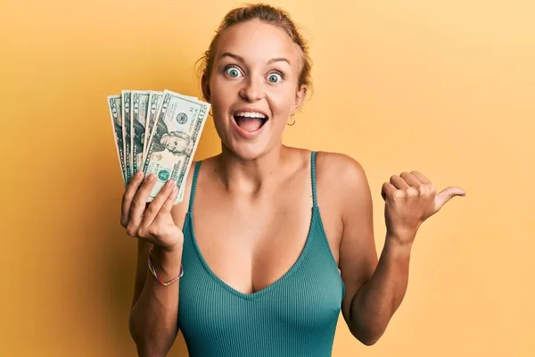 Vacker Kaukasisk Kvinna Håller Dollar Pekar Tummen Upp Till Sidan — Stockfoto