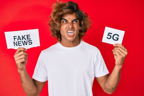 Young Hispanic Man Holding Fake News Banner Angry Mad Screaming — Stock Photo, Image