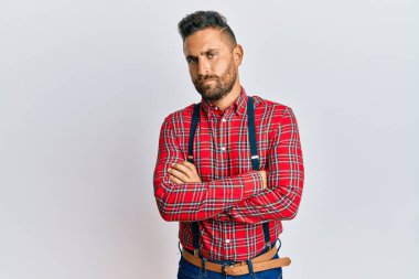 Handsome man with beard wearing hipster elegant look skeptic and nervous, disapproving expression on face with crossed arms. negative person.  clipart