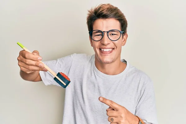 Handsome Caucasian Man Eating Sushi Using Chopsticks Smiling Happy Pointing — Stock Photo, Image