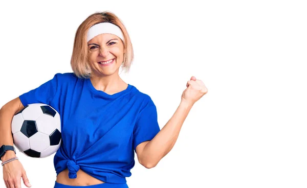Young Blonde Woman Holding Soccer Ball Screaming Proud Celebrating Victory — Stock Photo, Image