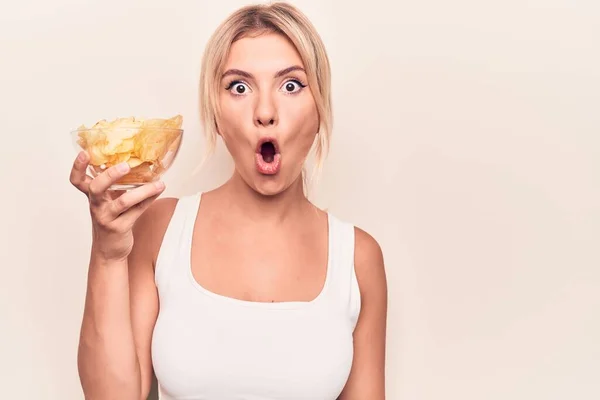 Young Beautiful Blonde Woman Holding Bowl Potatoes Chips Isolated White — Stock Photo, Image
