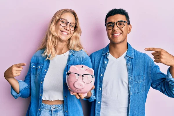 Jong Interraciaal Paar Holding Piggy Bank Met Bril Wijzend Vinger — Stockfoto