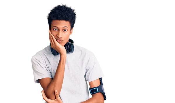 Hombre Afroamericano Joven Que Usa Ropa Gimnasio Usa Auriculares Pensando —  Fotos de Stock