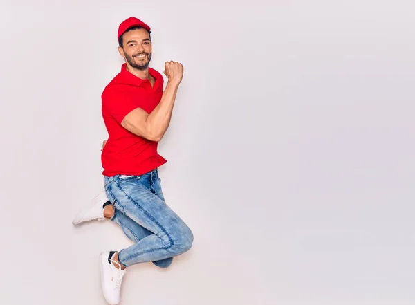 Young Handsome Hispanic Deliveryman Wearing Uniform Smiling Happy Jumping Smile — Stock Photo, Image