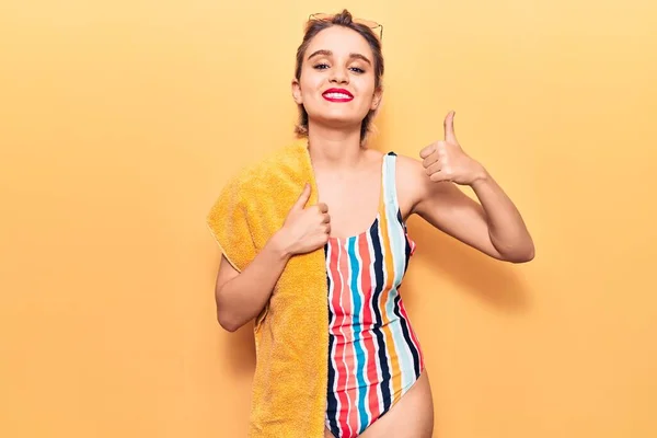Young Beautiful Blonde Woman Wearing Swimwear Holding Beach Towel Smiling — Stock Photo, Image