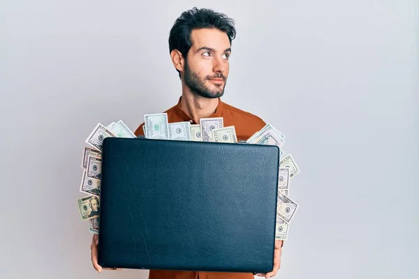 Young Hispanic Man Holding Briefcase Dollars Smiling Looking Side Staring — Stock Photo, Image