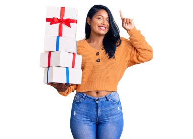 Uzun saçlı İspanyol bir kadın elinde hediyeler tutarken bir fikre ya da soru işaretine şaşırır. 