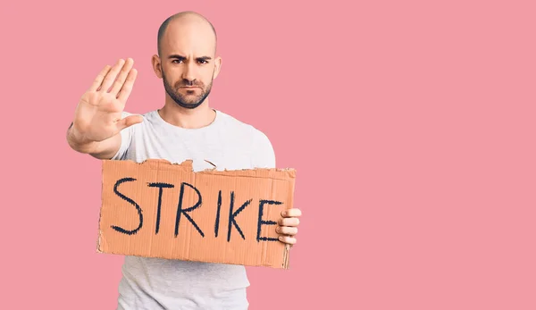 Young Handsome Man Holding Strike Banner Open Hand Doing Stop — Stock Photo, Image