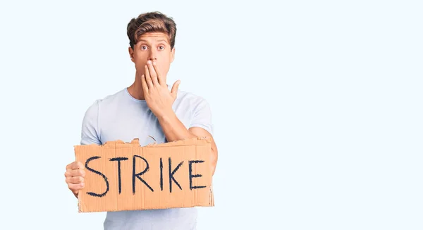 Young Handsome Man Holding Strike Banner Cardboard Covering Mouth Hand — Stock Photo, Image